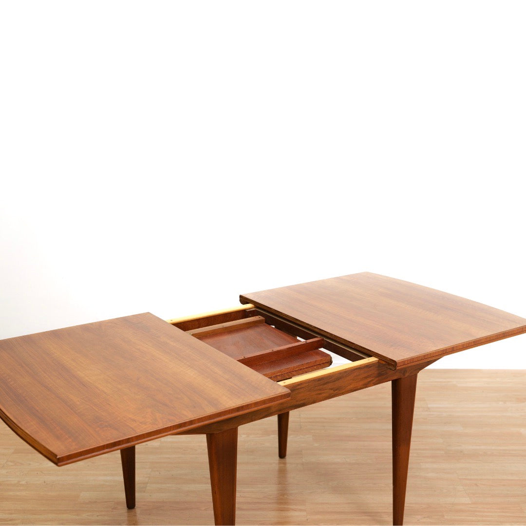 MID CENTURY ENGLISH WALNUT EXTENDING DINING TABLE BY ALFRED COX